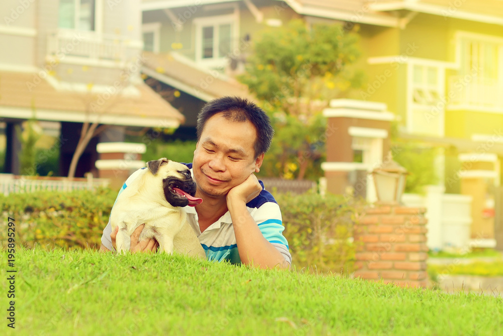 Happy Asian man playing with his dog in garden
Happy Asian man playing with his dog in garden