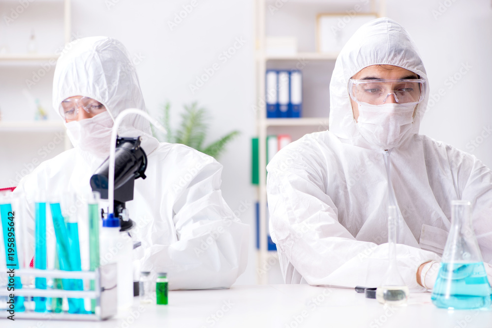 Two chemists working in the lab Two chemists working in the lab