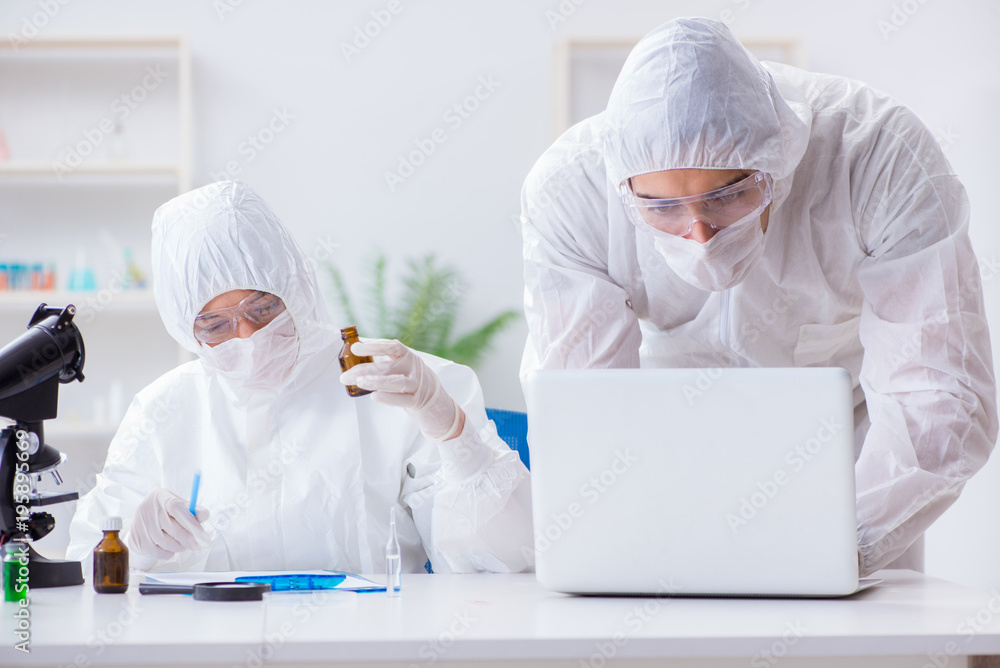 Two scientists working in the chemical lab Two scientists working in the chemical lab