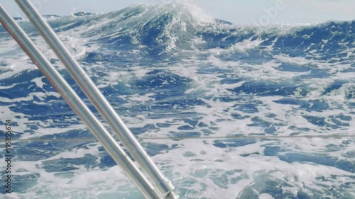 Slow motion view of ocean water over board of yacht