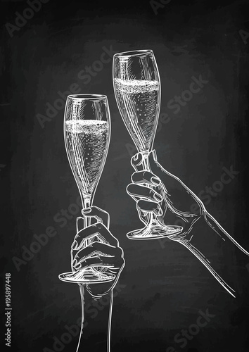 Two hands clinking glasses of champagne.