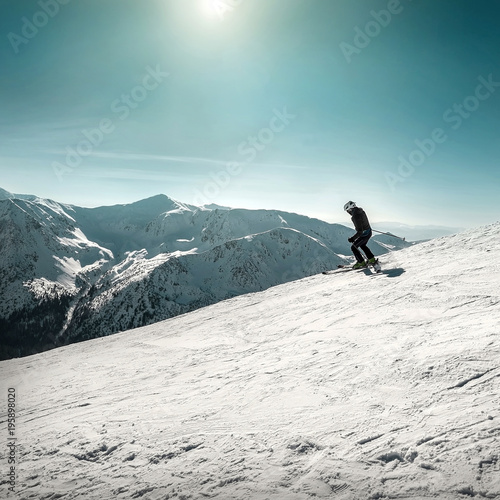Nice mountains view at sunny day with skiers under blue sky with © Andrii IURLOV