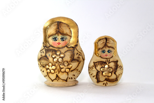 Two wooden nested dolls on a white background close-up