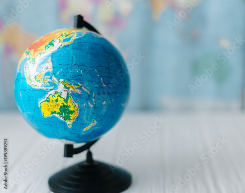 3312236 Globe on a wooden white background. The concept of travel