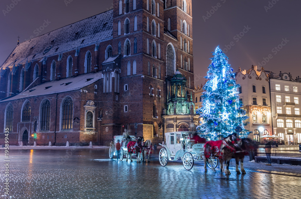 Krakow, Poland, Christmas tree and St Mary's church on Main Market square