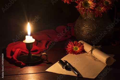 The candle illuminates the Desk where the letter