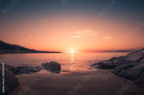 Sunset on sandy Algajola beach in Corsica