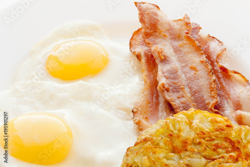 Valokuva Fried Eggs, Bacon and Potatoes hash browns on a white background