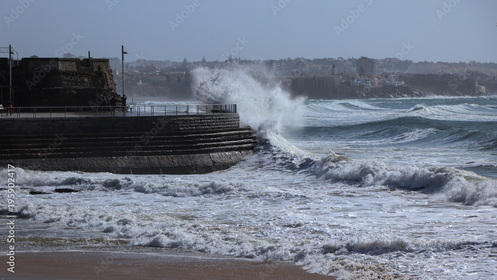 Big storm waves reach a breakwater structure in a pier in the Atlantic coastline. Cascais Portugal