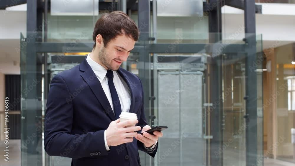Handsome Businessman Using Smartphone in The Office. Handsome Businessman Using Smartphone in The Office.