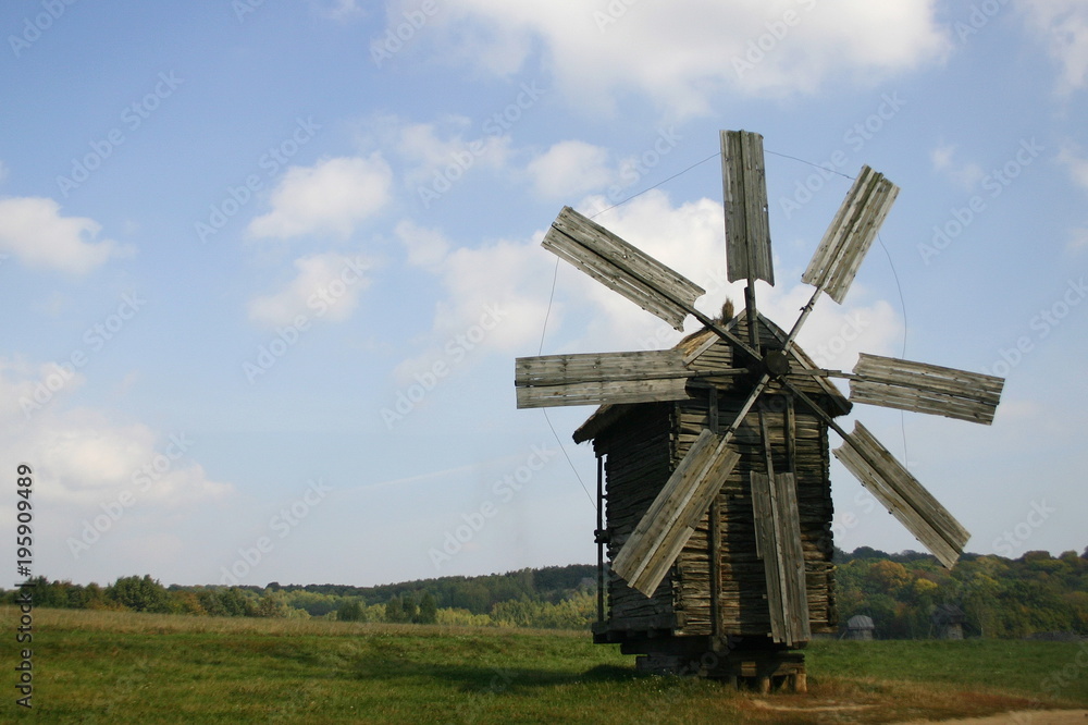 old wood windmill in the field old wood windmill in the field