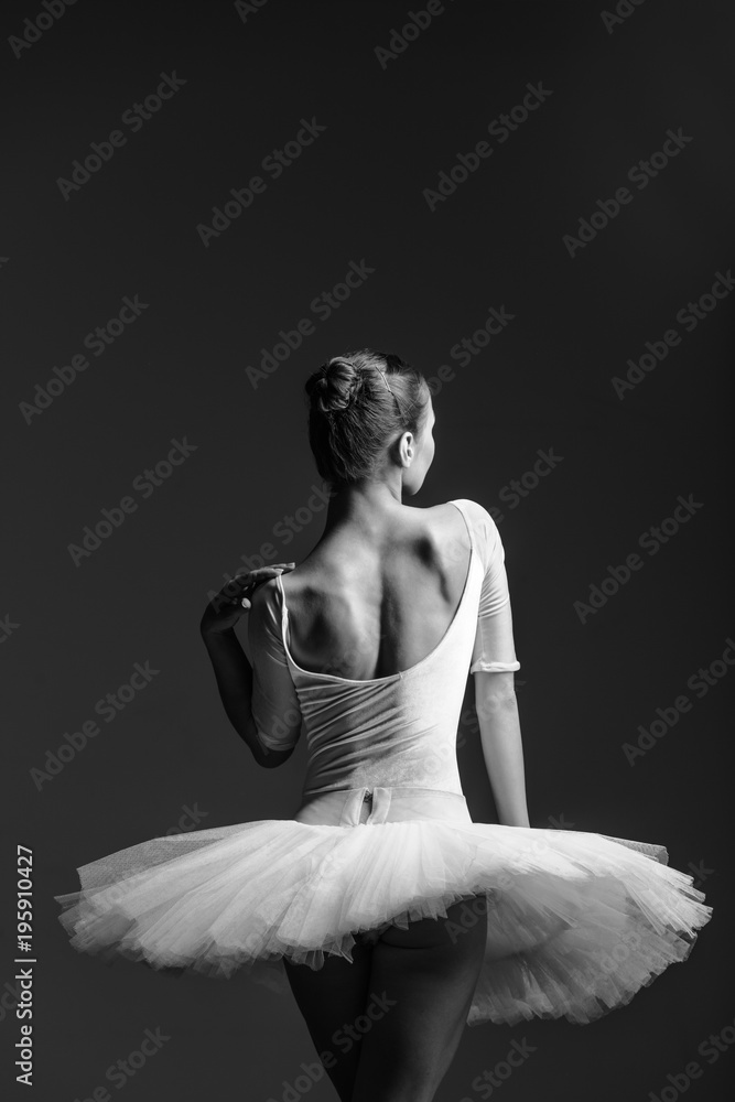 Naklejka premium Young beautiful ballerina is posing in studio