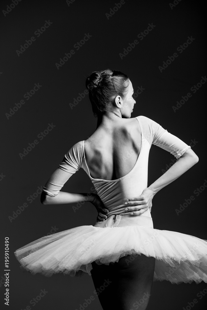 Fototapeta premium Young beautiful ballerina is posing in studio