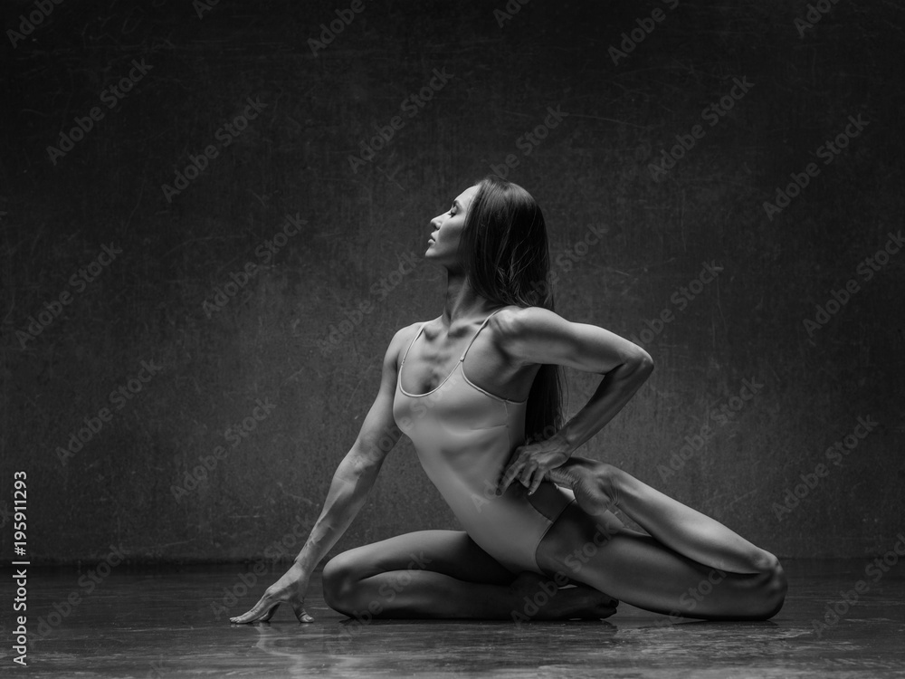 Young yoga woman stretching and training in class Young yoga woman stretching and training in class