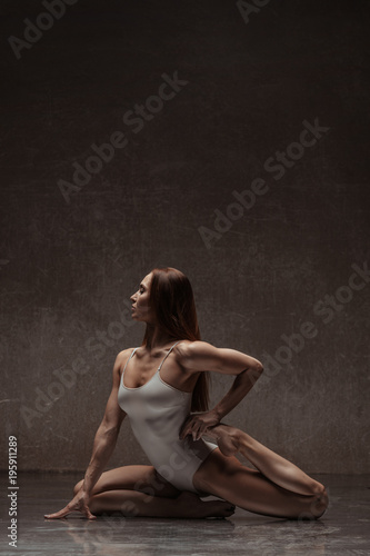 Young yoga woman stretching and training in class 
