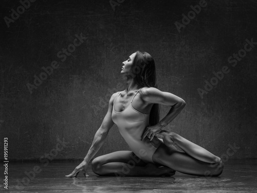 Young yoga woman stretching and training in class 