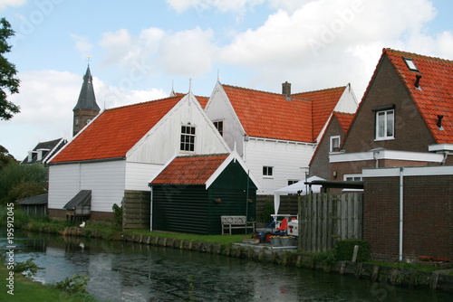 wooden houses with red roofs in the Marken village Netherlands © Tetiana