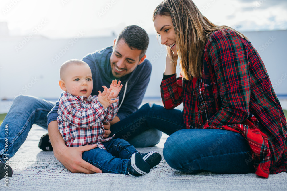 Fototapeta premium happy family mother and father playing with a baby at home