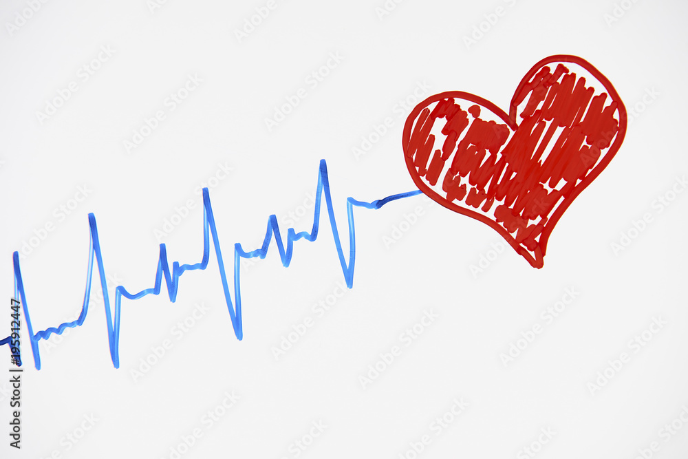Cardiogram pulse trace and red heart concept for cardiovascular medical exam on a white background with copy space, top view. Healthcare concept