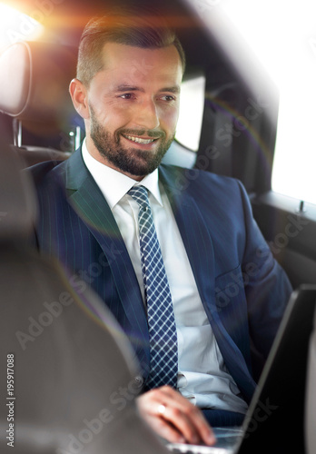 Portrait of a business man in the back seat of a car © ASDF