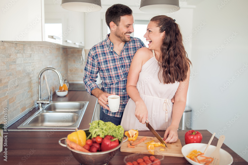 Young couple having fun in the kitchen Young couple having fun in the kitchen