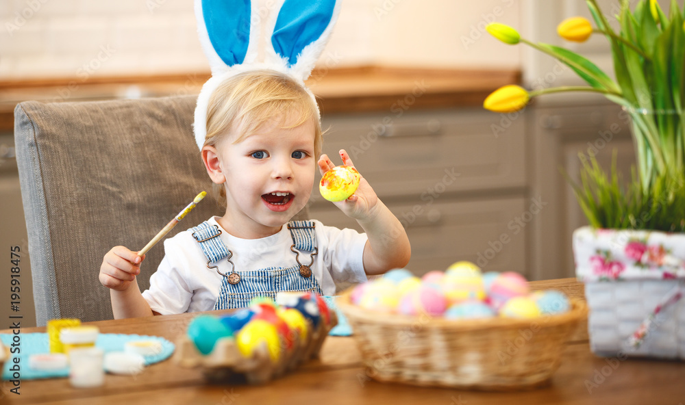 Happy easter! child paints eggs Happy easter! child paints eggs