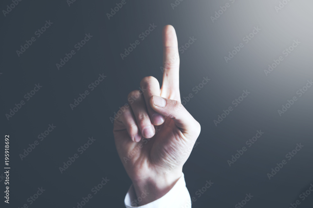 man hand touching his index finger on a gray background man hand touching his index finger on a gray background