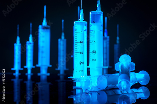 Syringes on a black table. ...