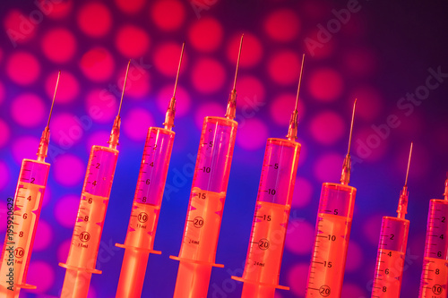 Red syringes on the backgro...