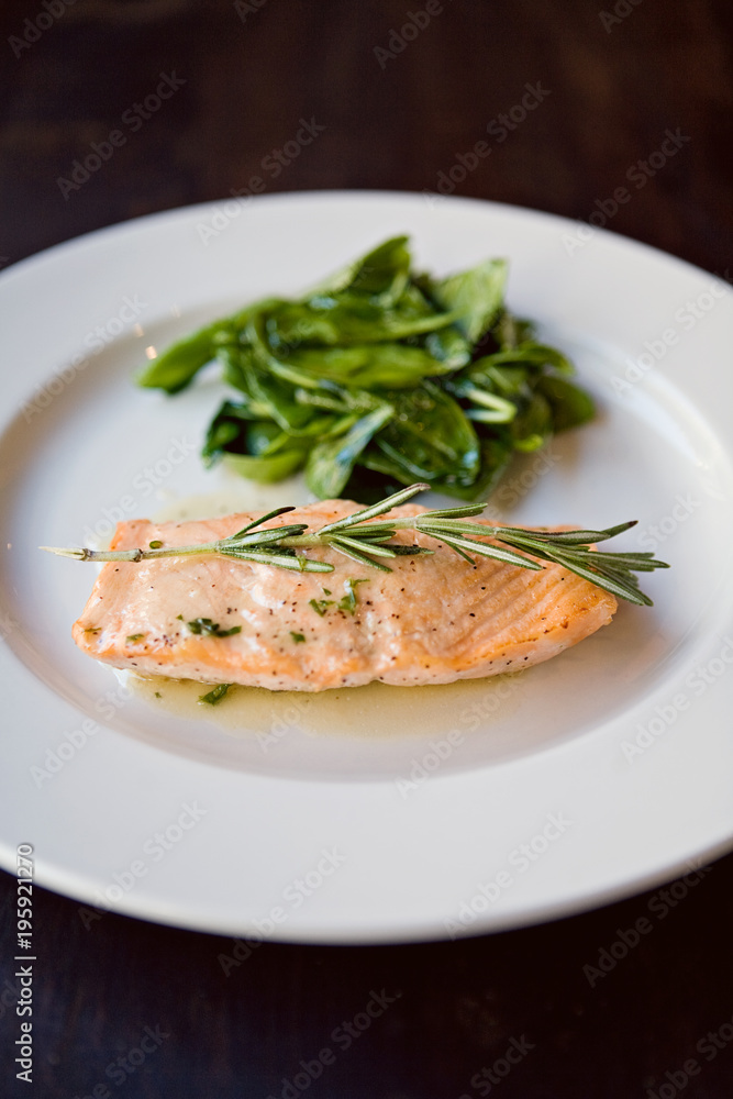 Plated salmon with rosemary and salad