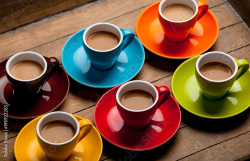Six colorful cups of coffee