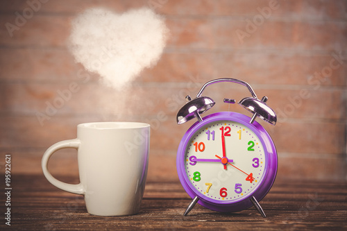 coffee with heart shape steam and alarm clock