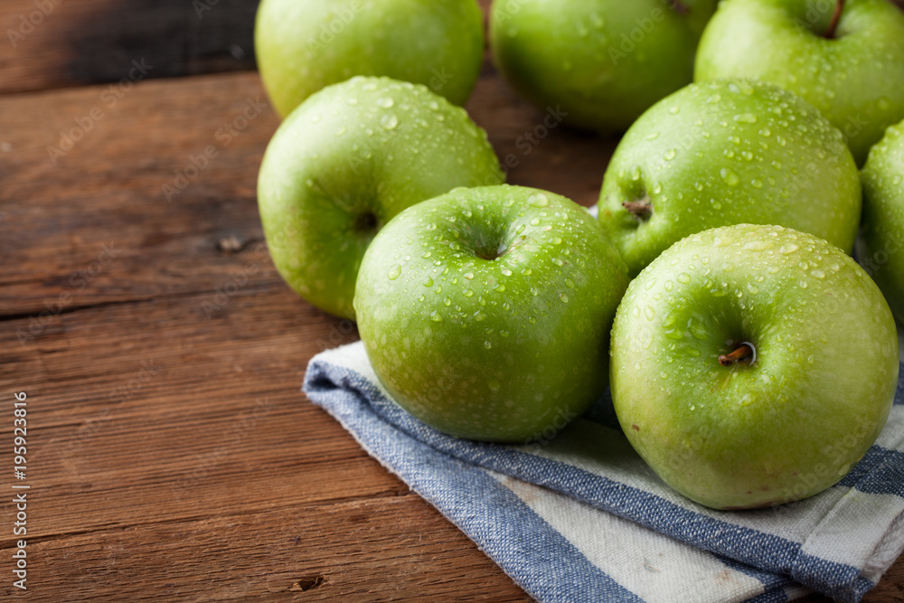 Ripe green apples in a wooden bowl on an old rustic table. Useful fruits on wooden background. with copy space Ripe green apples in a wooden bowl on an old rustic table. Useful fruits on wooden background. with copy space