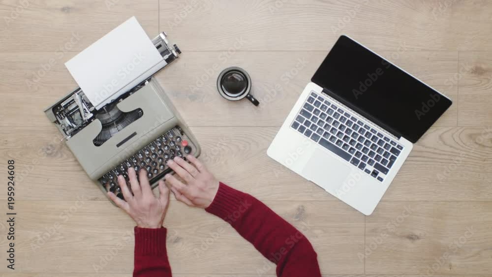 Old vs New technology. Typing on both modern computer laptop and old