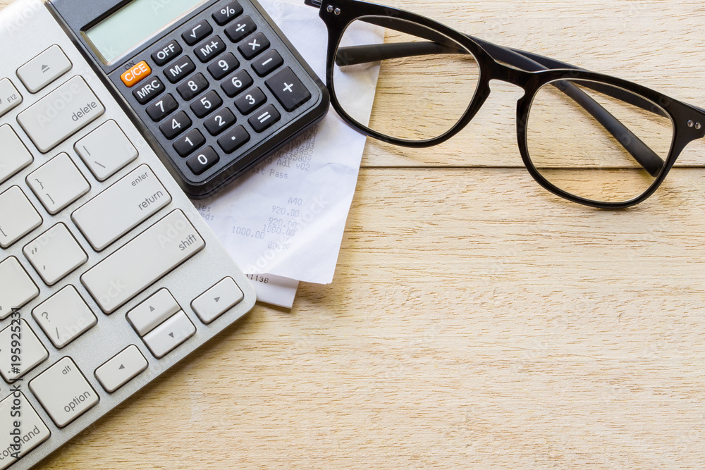 retail online shopping cart icon button on a keyboard, calculator and receipt on table retail online shopping cart icon button on a keyboard, calculator and receipt on table