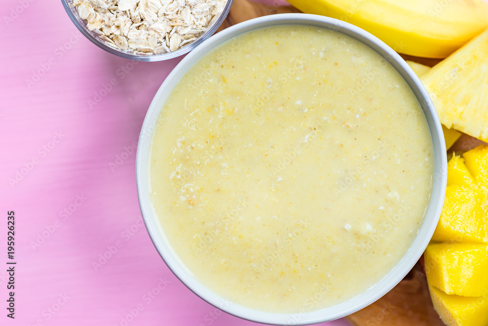 Mango, Banana, Pineapple and Oatmeal Smoothie in the Bowl Mango, Banana, Pineapple and Oatmeal Smoothie in the Bowl