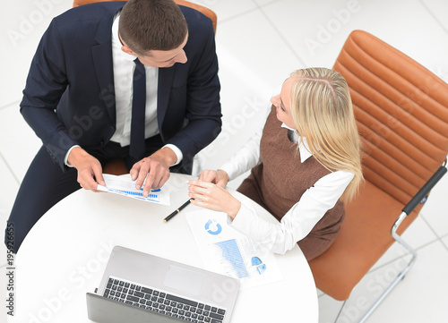 businessman and business woman discussing marketing scheme