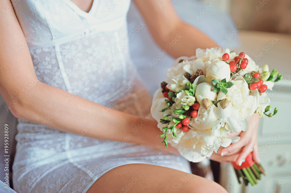Wedding bridal bouquet in the hands of bride before wedding ceremony with decoration a lot of flowers and colorful tape shot taken by selective soft focus and macro Wedding bridal bouquet in the hands of bride before wedding ceremony with decoration a lot of flowers and colorful tape shot taken by selective soft focus and macro