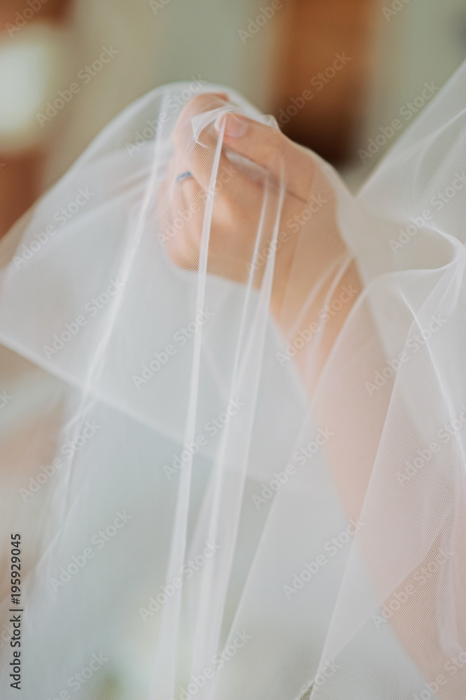 Beautiful bride model in white lace lingerie. Close-up of a female buttocks on the table. Girl in panties, belt, and stockings. Hosiery underwear. Portrait of sexy fashion woman Beautiful bride model in white lace lingerie. Close-up of a female buttocks on the table. Girl in panties, belt, and stockings. Hosiery underwear. Portrait of sexy fashion woman