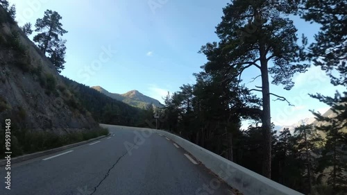 Motorcyclist Rides on the Scenic Mountain Road on Serpentine in the Mountains of France. Provence. First-person view. Viewpoint of a biker riding down a picturesque and empty road toward the mountains photo