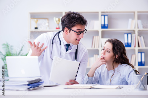 Female patient visiting male doctor for regular check-up in hosp