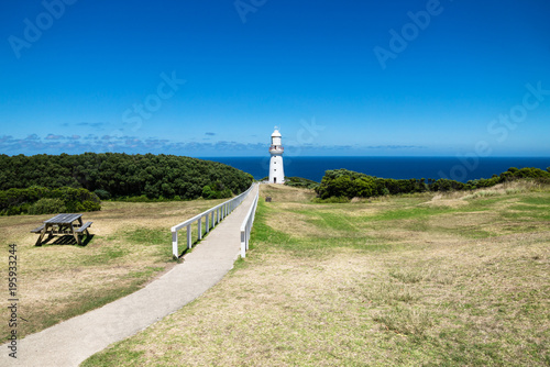 Cape Otway Lighthouse in grasslandpark with bench and overlook at the ocean at the Great Ocean Road  Victoria  Australia