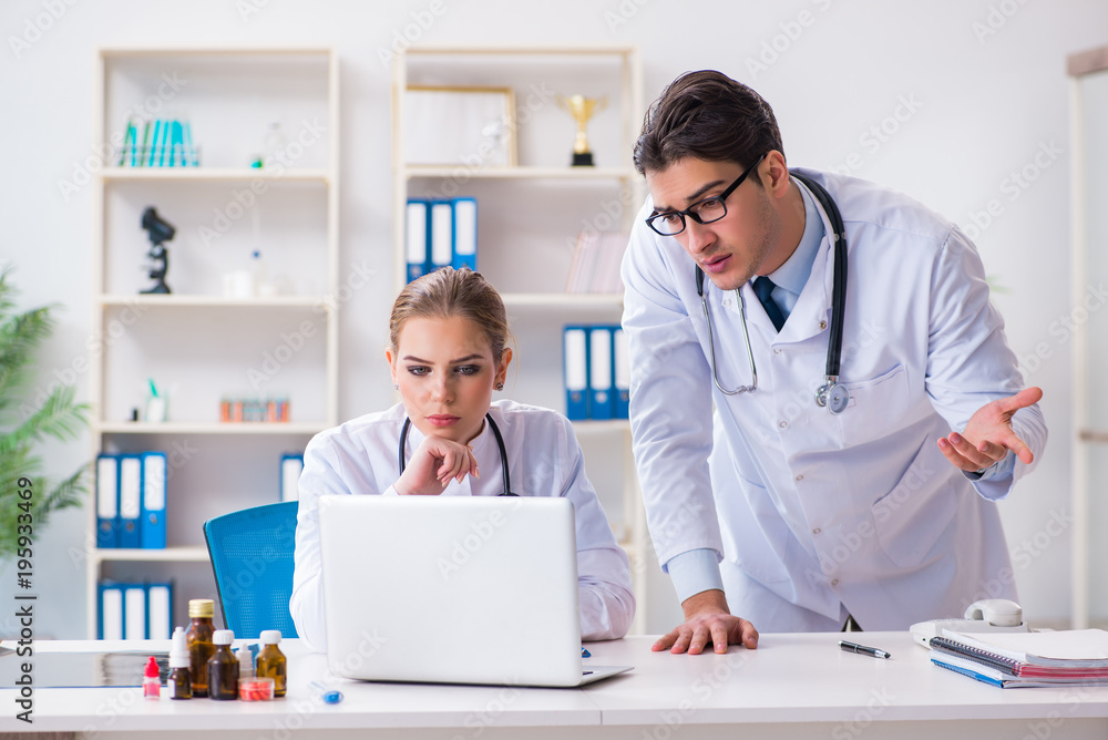 Male and female doctor having discussion in hospital Male and female doctor having discussion in hospital
