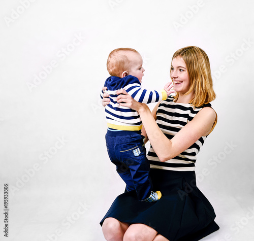 Mother and baby boy against white background photo