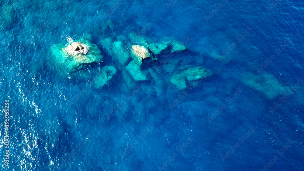 Aerial photo rocks in clear blue sea Aerial photo rocks in clear blue sea