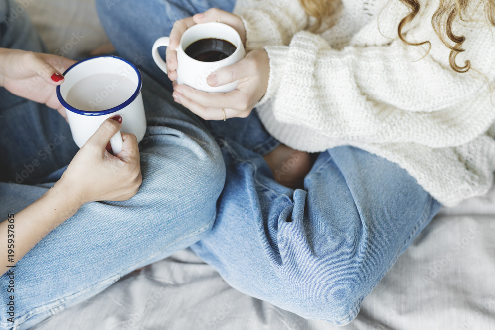 Women couple with hot drinks in winter