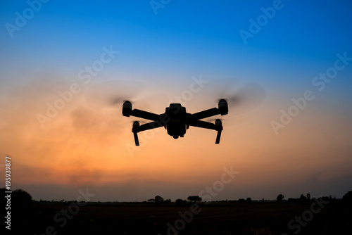 Black silhouette Flying drone and cloud sunset sky