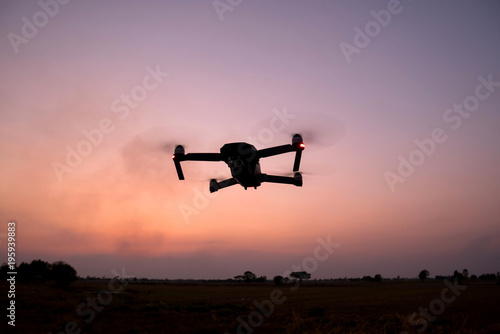 Black silhouette Flying drone and cloud sunset sky