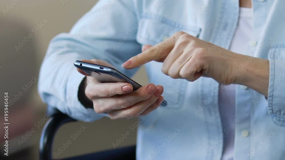 Mature lady scrolling smartphone, viewing photos from her past, using gadget Mature lady scrolling smartphone, viewing photos from her past, using gadget