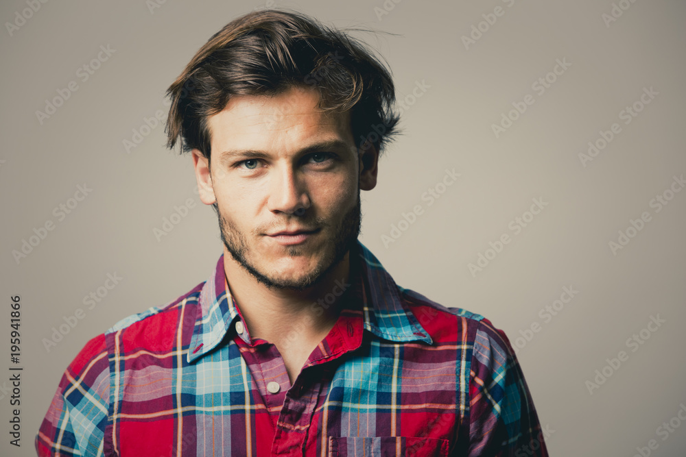 Obraz premium caucasian man wearing checkered shirt and trendy hairstyle